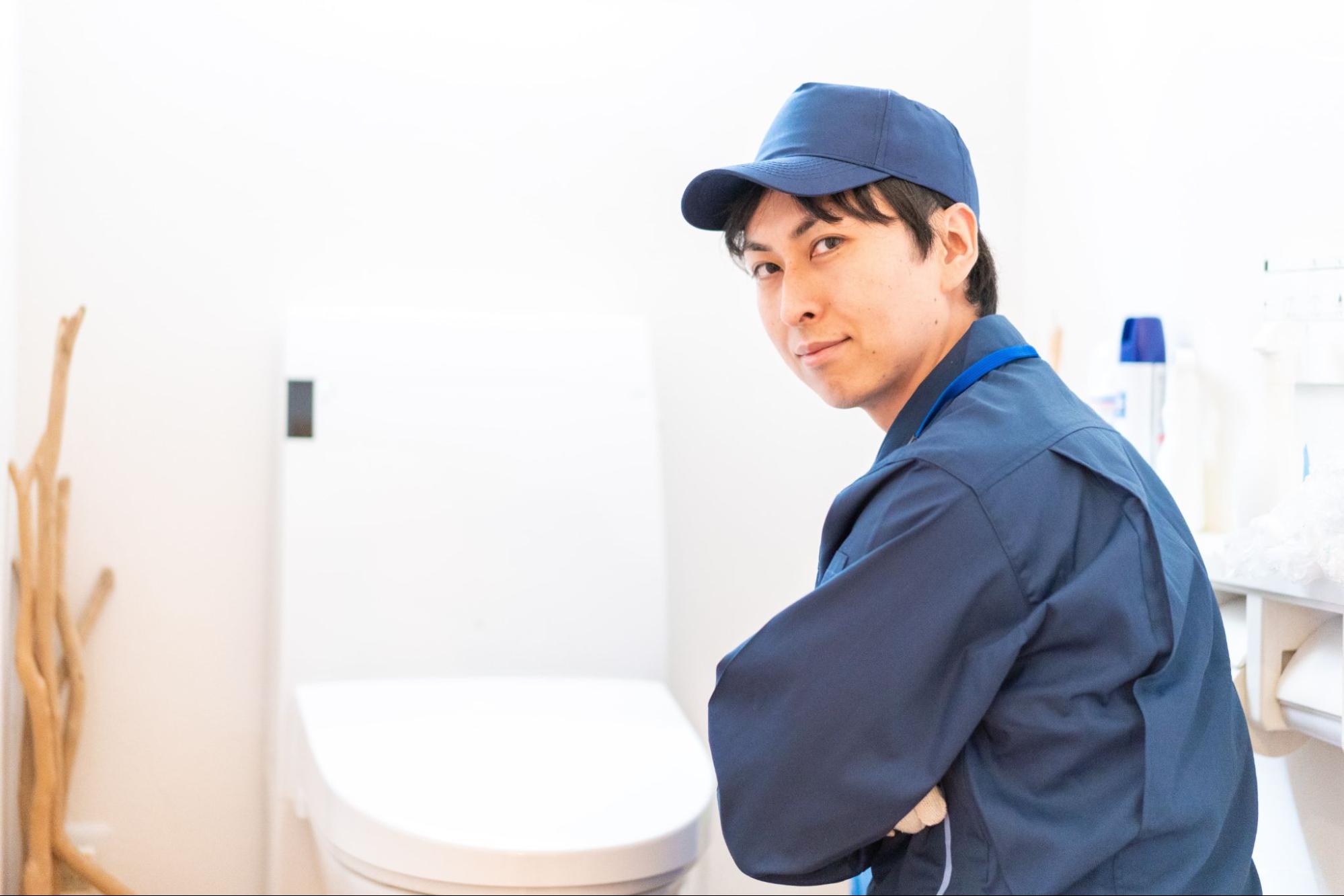 plumber conducting toilet maintenance